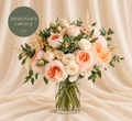 Designer's Choice Pastels bouquet of peach, blush, and cream flowers in a clear vase