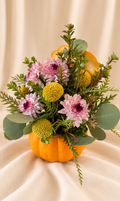 Fresh pink mums + craspedia in orange pumpkin vessel