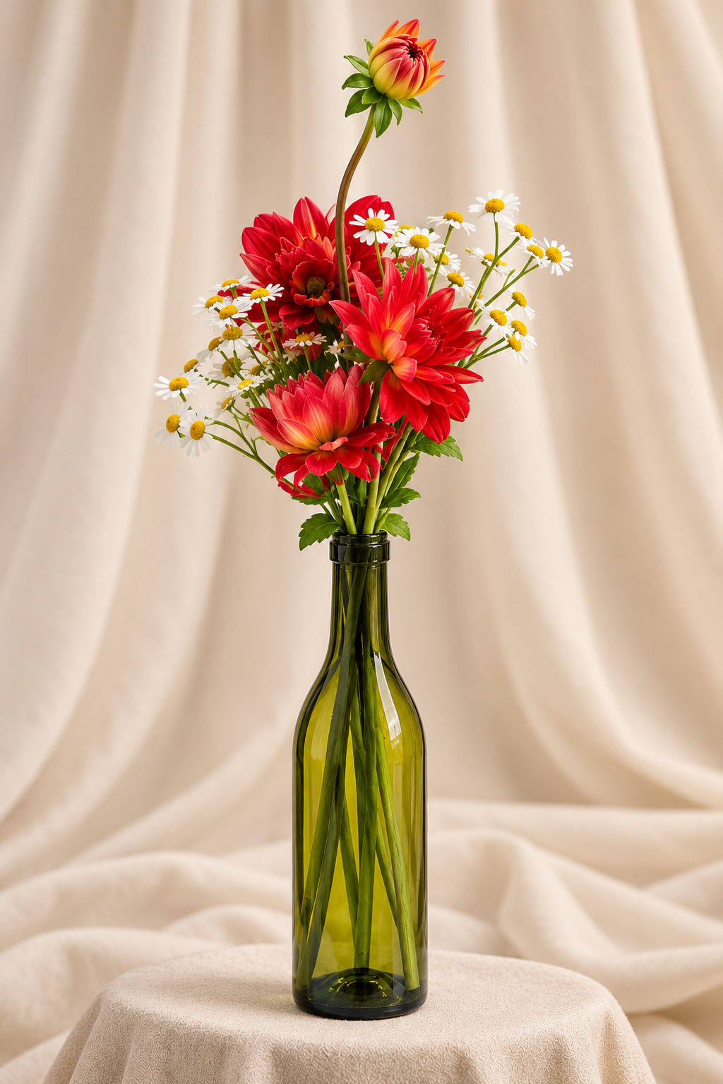 Red dahlias + chamomile in wine bottle