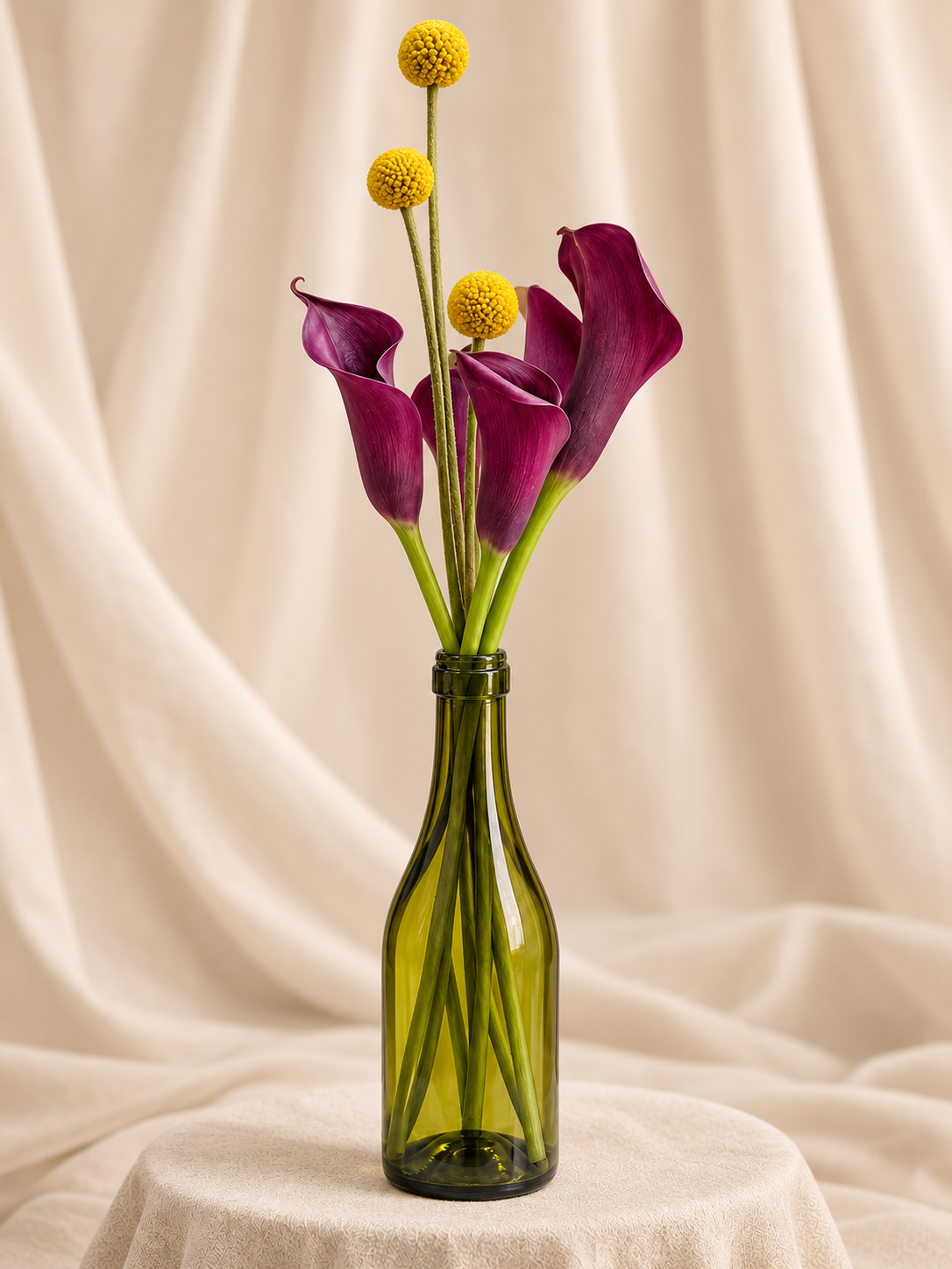 Purple calla lilies + billy balls in wine bottle