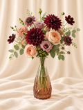 Burgundy dahlias + mauve lisianthus and scabiosa + peach garden roses + chocolate cosmos + sage eucalyptus in a faceted rose-amber glass vase.