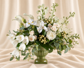 White tulips, calla lilies, irises and pale roses + eucalyptus in a green pedestal urn.